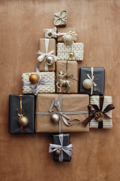 Christmas presents wrapped in matching browns, whites and golds and contrasting ribbons. Christmas presents wrapped in matching browns, whites and golds and contrasting ribbons.
