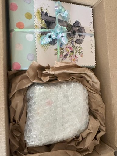 Customer wrapped present as a fabulous review for our services Present wrapped in pale blue paper with homemade gift tag attached