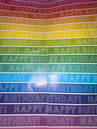 Rainbow effect wrapping paper that customer sent a photo of as a review. Rainbow effect wrapping paper