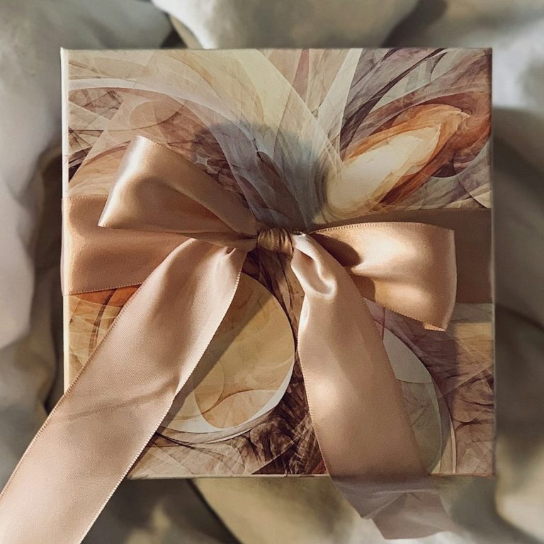 Cream, Gold & Brown gift box tied with a muted apricot satin bow. Cream, Gold & Brown gift box tied with a muted apricot satin bow.