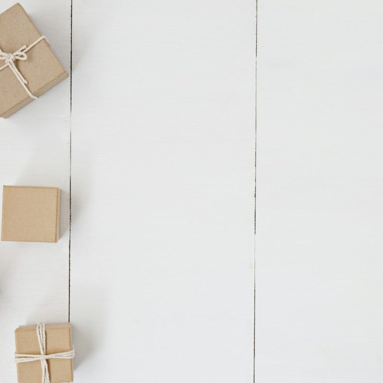 Eco-friendly wrapping options Cardboard boxes and string invoking themes of nature and being kind to the environment and using recyclable materials.